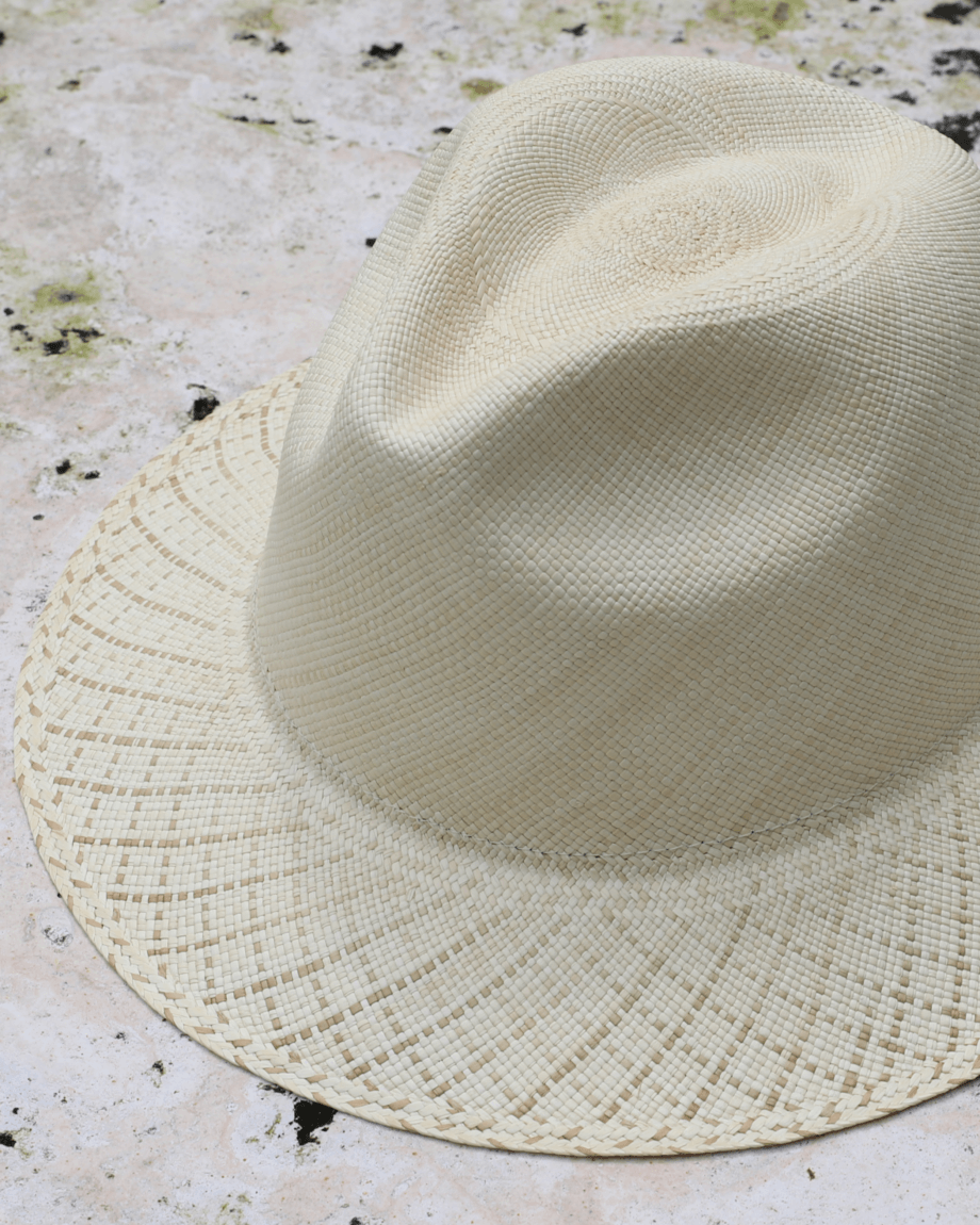Ivory panama toquilla straw hat with pinched crown and beige-patterned brim