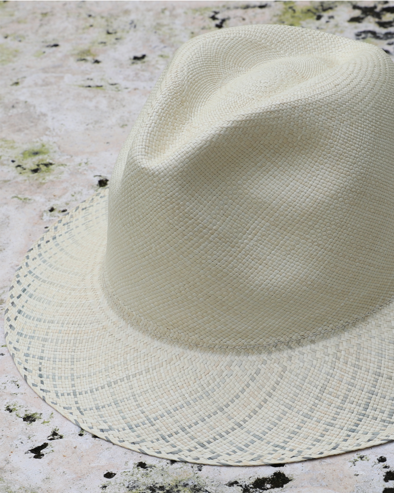 Ivory panama toquilla straw hat with pinched crown and blue-patterned brim